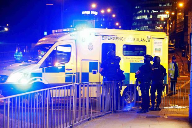 Armed police officers stand near the Manchester Arena in Manchester on May 23 2017 Reut